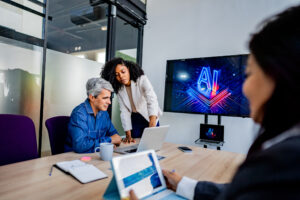 Coworkers talking and using laptop during business meeting on the office
