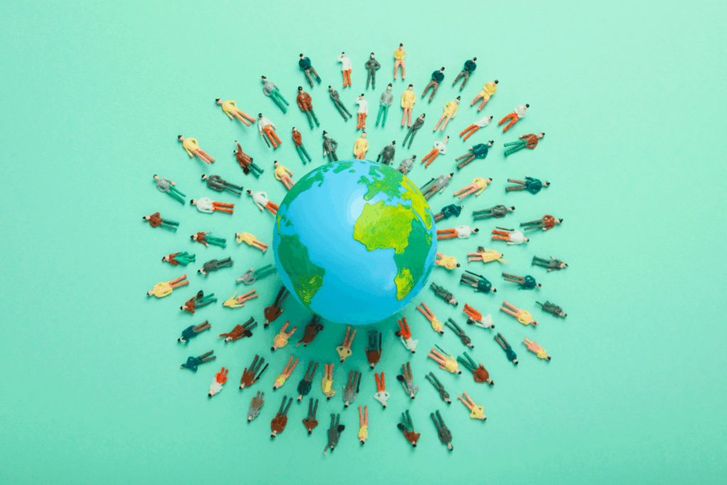 globe with people standing around it